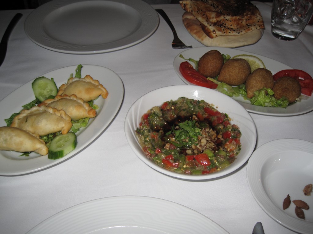 Had dinner at a Lebanese restaurant. Baba Ghanoush in the middle, kubbeh (meat and bulgur dough stuffed with meat and pine nuts) to the right, and cheese burek (cheese stuffed pastries) to the left